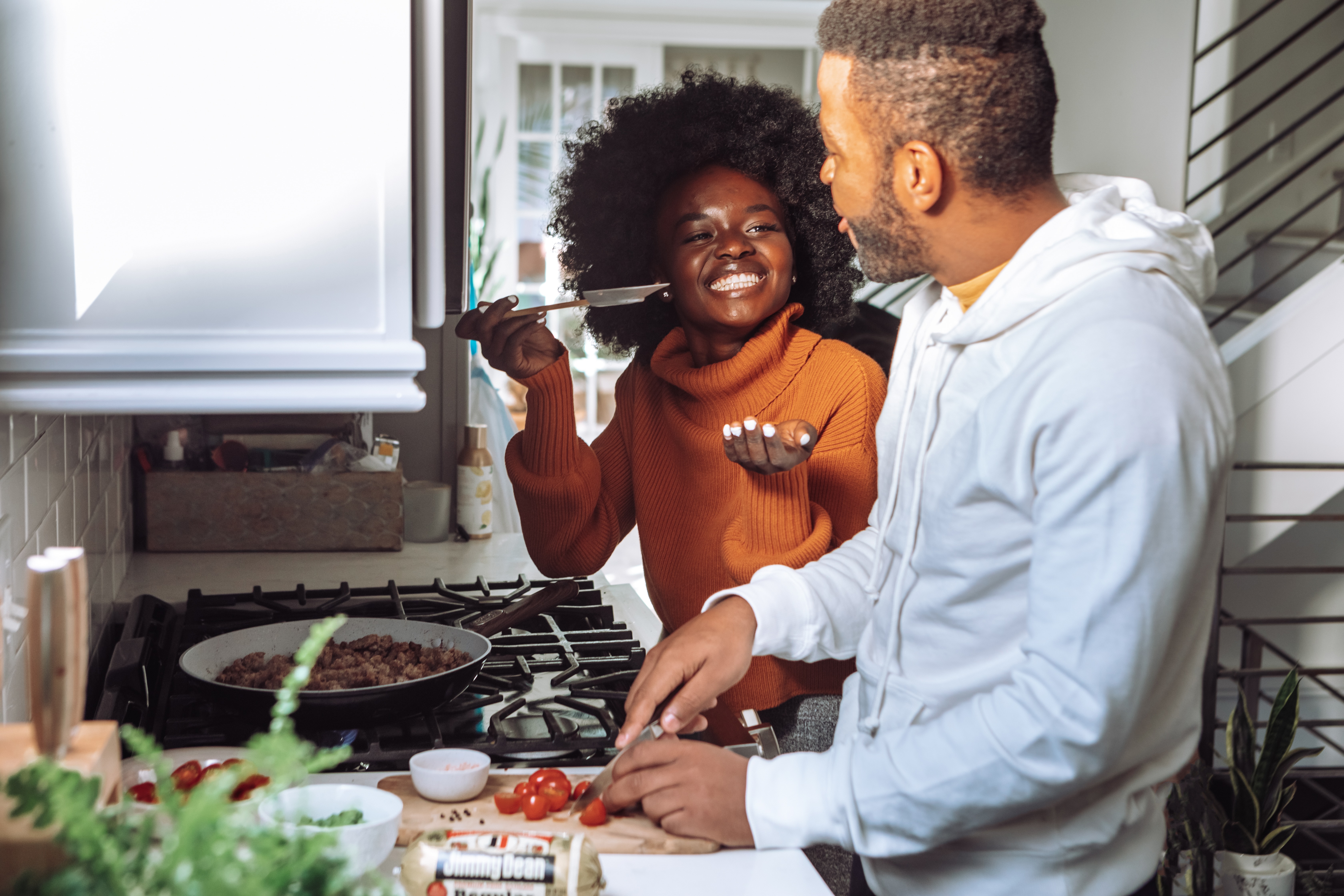 Photo of people cooking in their kitchen happily